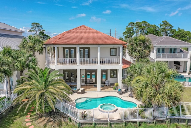 4720 Rendezvous Cv, Destin, FL 32541 - rear view of house featuring a balcony, a tiled roof, stucco siding, a patio area, and fence