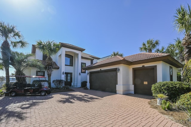 4720 Rendezvous Cv, Destin, FL 32541 - mediterranean / spanish home featuring stucco siding, a garage, a tile roof, and decorative driveway