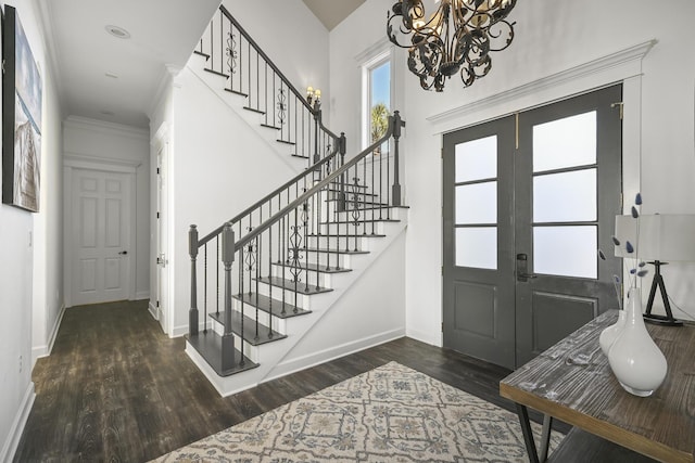 4720 Rendezvous Cv, Destin, FL 32541 - foyer with stairway, a chandelier, wood finished floors, baseboards, and ornamental molding