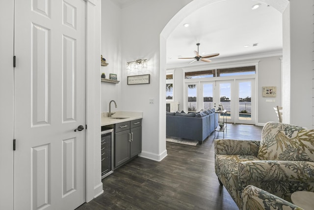 4720 Rendezvous Cv, Destin, FL 32541 - living area with crown molding, arched walkways, baseboards, a ceiling fan, and dark wood finished floors