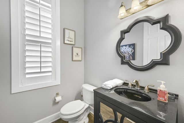 4720 Rendezvous Cv, Destin, FL 32541 - bathroom featuring toilet, vanity, and baseboards