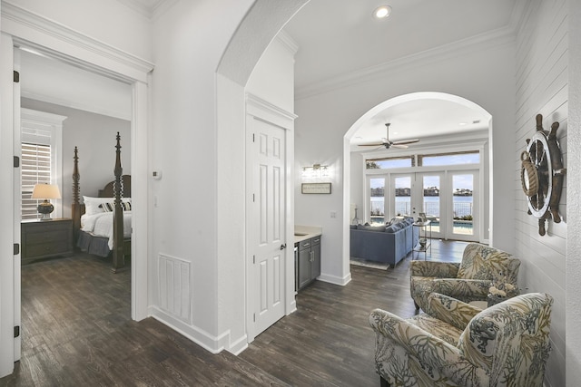 4720 Rendezvous Cv, Destin, FL 32541 - corridor featuring arched walkways, french doors, dark wood finished floors, crown molding, and baseboards
