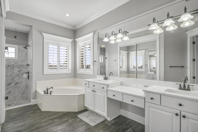 4720 Rendezvous Cv, Destin, FL 32541 - bathroom with a stall shower, wood finished floors, a bath, vanity, and crown molding