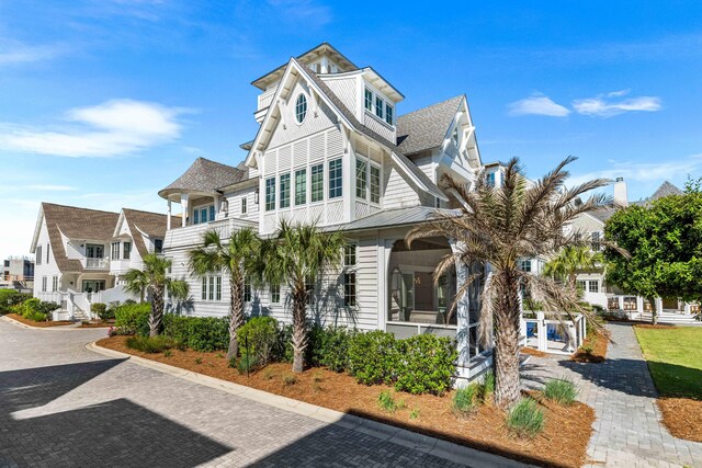 view of front of house featuring a standing seam roof and roof with shingles