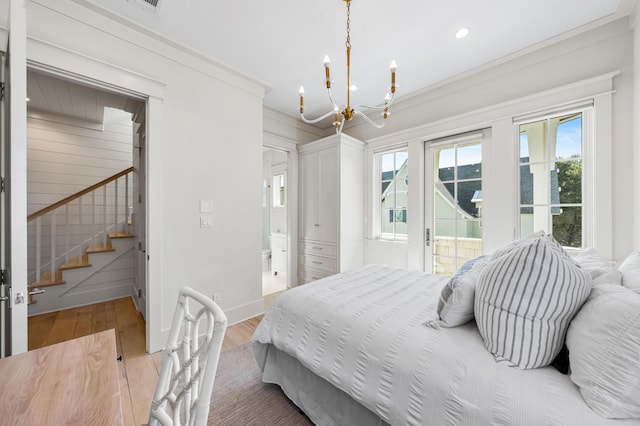bedroom with recessed lighting, an inviting chandelier, access to outside, light wood-style flooring, and ornamental molding