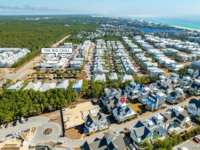 bird's eye view featuring a water view, a view of trees, and a residential view