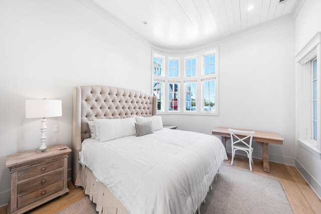 bedroom featuring crown molding, recessed lighting, multiple windows, and wood finished floors