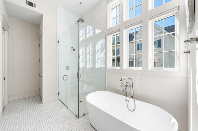 full bath featuring visible vents, a freestanding bath, and a stall shower