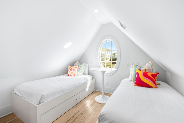 bedroom featuring recessed lighting, lofted ceiling, visible vents, baseboards, and wood finished floors