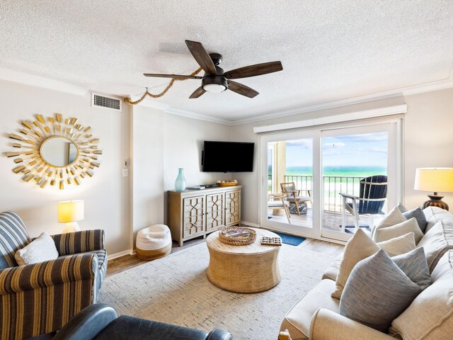 5801 Thomas Dr Unit 415, Panama City Beach, FL 32408 - living room with ornamental molding, a ceiling fan, wood finished floors, and visible vents