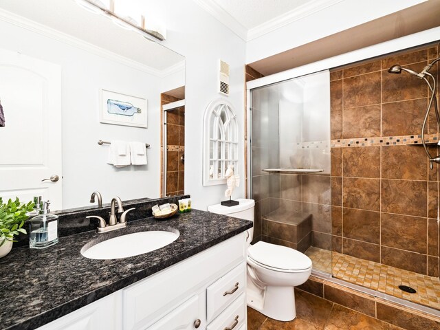 5801 Thomas Dr Unit 415, Panama City Beach, FL 32408 - bathroom with toilet, visible vents, a shower stall, vanity, and ornamental molding