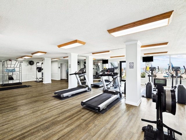 5801 Thomas Dr Unit 415, Panama City Beach, FL 32408 - exercise room featuring a textured ceiling and a healthy amount of sunlight