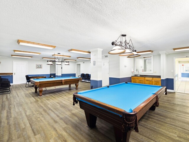 5801 Thomas Dr Unit 415, Panama City Beach, FL 32408 - game room featuring a textured ceiling, a sink, baseboards, wood finished floors, and pool table