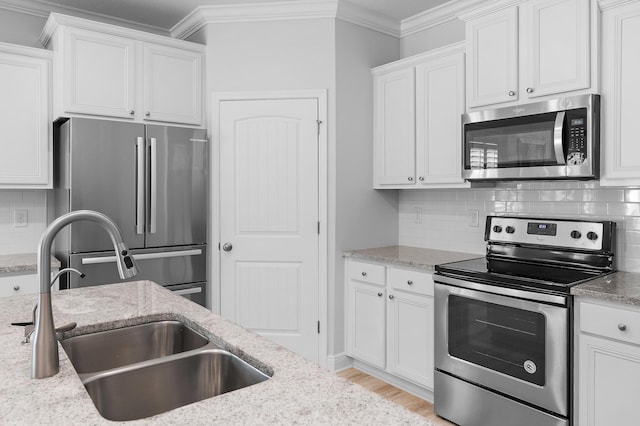 85 Stonegate Dr, Santa Rosa Beach, FL 32459 - kitchen with white cabinets, crown molding, stainless steel appliances, and a sink