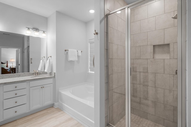 85 Stonegate Dr, Santa Rosa Beach, FL 32459 - full bath with wood finished floors, a stall shower, a bath, vanity, and ensuite bath
