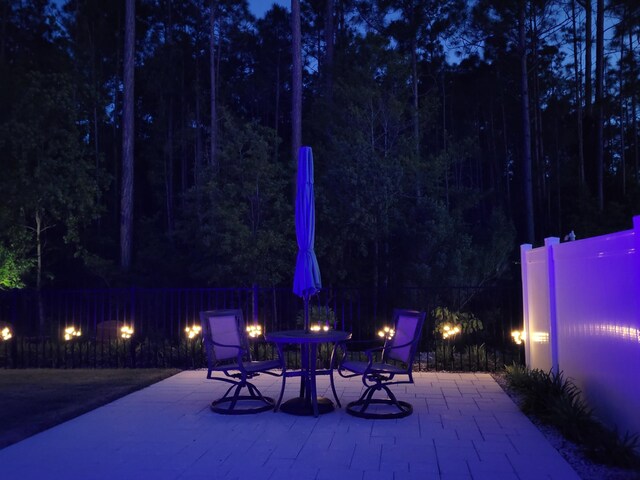 85 Stonegate Dr, Santa Rosa Beach, FL 32459 - patio at twilight with a fire pit and fence