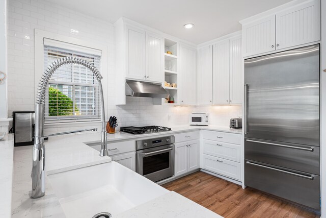 265 Salt Box Ln, Watersound, FL 32461 - kitchen featuring open shelves, light countertops, under cabinet range hood, stainless steel appliances, and white cabinetry