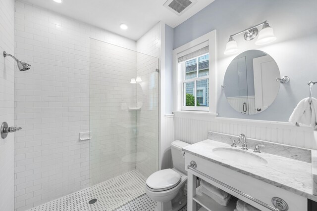265 Salt Box Ln, Watersound, FL 32461 - full bath with wainscoting, vanity, toilet, a shower stall, and visible vents