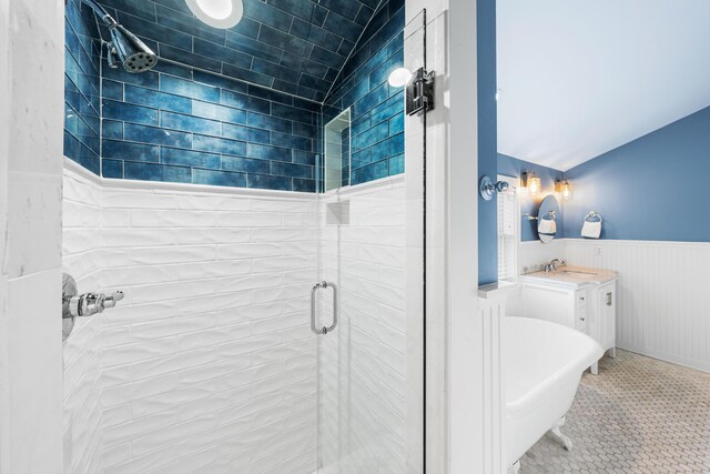265 Salt Box Ln, Watersound, FL 32461 - bathroom featuring tile patterned flooring, wainscoting, a shower stall, vanity, and a soaking tub