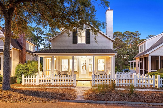 265 Salt Box Ln, Watersound, FL 32461 - rear view of house featuring covered porch, a chimney, fence private yard, and a sunroom