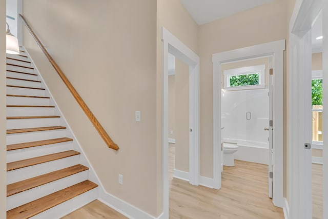 4003 Tarpon St, Panama City Beach, FL 32408 - stairs with baseboards, wood finished floors, and a healthy amount of sunlight