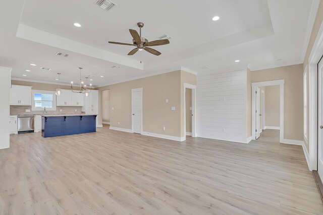 4003 Tarpon St, Panama City Beach, FL 32408 - unfurnished living room featuring visible vents, ceiling fan, light wood-type flooring, and a tray ceiling