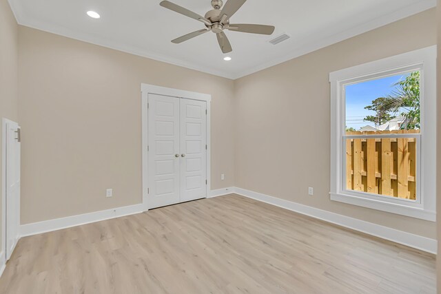 4003 Tarpon St, Panama City Beach, FL 32408 - unfurnished bedroom featuring recessed lighting, a closet, crown molding, light wood-style flooring, and baseboards