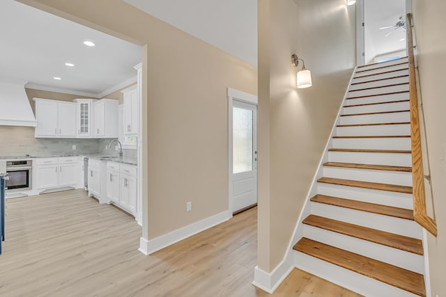 4003 Tarpon St, Panama City Beach, FL 32408 - staircase featuring baseboards, recessed lighting, ornamental molding, wood finished floors, and a ceiling fan