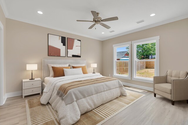 4003 Tarpon St, Panama City Beach, FL 32408 - bedroom with baseboards, visible vents, ornamental molding, and light wood-style flooring