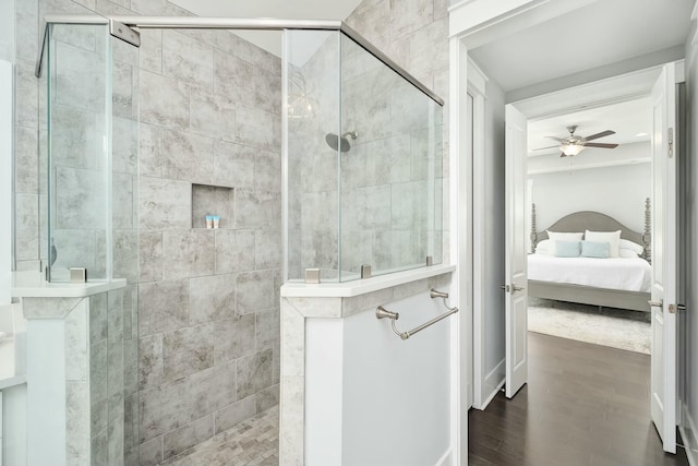 ensuite bathroom featuring a walk in shower, a ceiling fan, connected bathroom, and wood finished floors