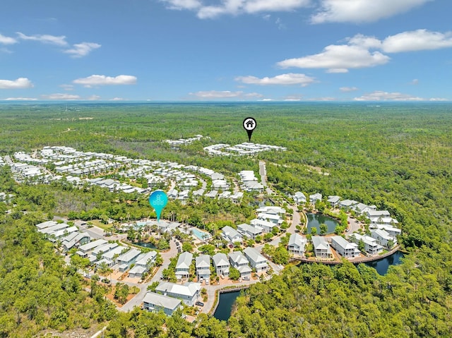 bird's eye view featuring a forest view, a water view, and a residential view