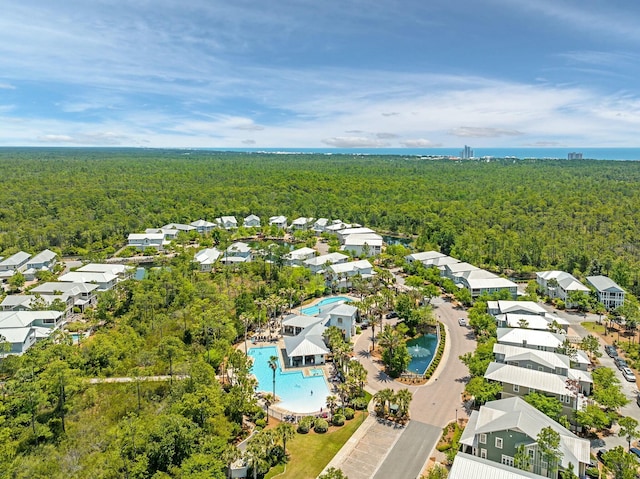 drone / aerial view featuring a residential view and a forest view