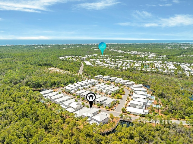 drone / aerial view with a residential view and a wooded view