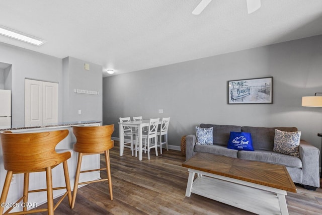 9900 S Thomas Dr Unit 1408, Panama City Beach, FL 32408 - living room with baseboards, a ceiling fan, and wood finished floors