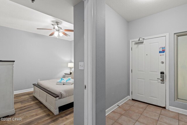 9900 S Thomas Dr Unit 1408, Panama City Beach, FL 32408 - foyer entrance featuring baseboards, a ceiling fan, and light wood-style floors
