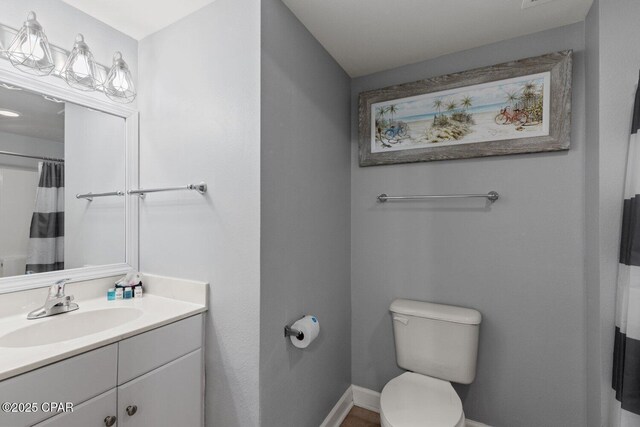 9900 S Thomas Dr Unit 1408, Panama City Beach, FL 32408 - full bathroom featuring baseboards, vanity, and toilet
