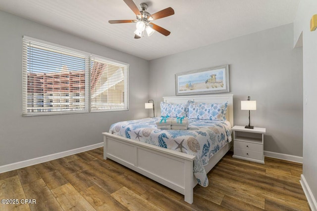bedroom with baseboards, a ceiling fan, and wood finished floors