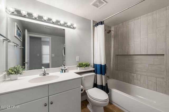 bathroom featuring vanity, toilet, visible vents, and shower / bath combination with curtain