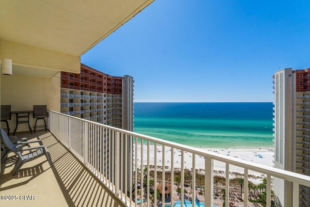 balcony featuring a water view and a view of the beach