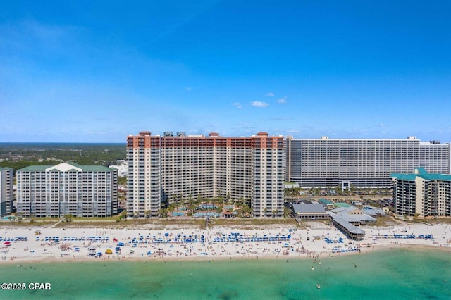 birds eye view of property featuring a water view, a view of city, and a beach view