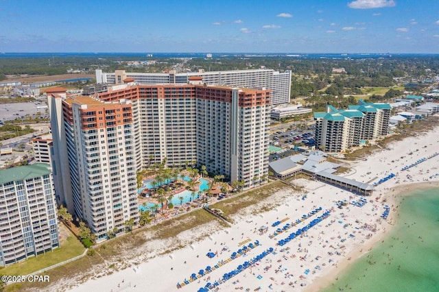 aerial view featuring a city view, a water view, and a beach view