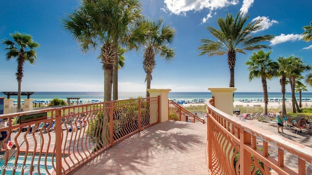 exterior space with a water view and a beach view