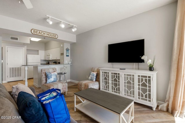 9900 S Thomas Dr Unit 1410, Panama City Beach, FL 32408 - living area featuring visible vents, light wood-style floors, and baseboards
