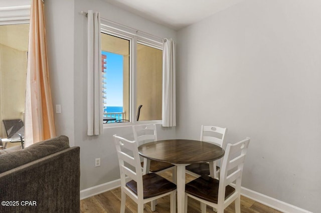 9900 S Thomas Dr Unit 1410, Panama City Beach, FL 32408 - dining area featuring baseboards and wood finished floors