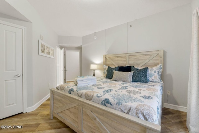 9900 S Thomas Dr Unit 1410, Panama City Beach, FL 32408 - bedroom featuring baseboards and wood finished floors