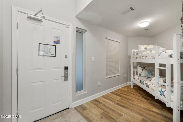9900 S Thomas Dr Unit 1410, Panama City Beach, FL 32408 - entrance foyer with baseboards, visible vents, and light wood-style floors