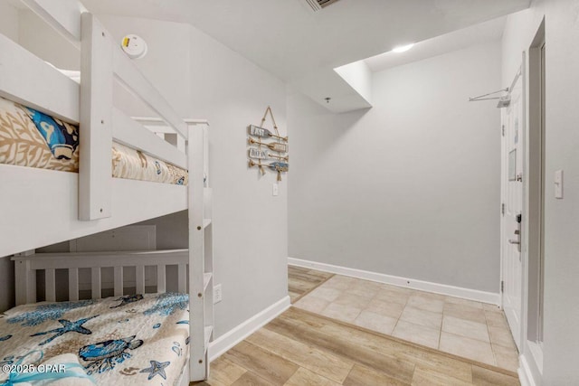 9900 S Thomas Dr Unit 1410, Panama City Beach, FL 32408 - bedroom with baseboards and wood finished floors
