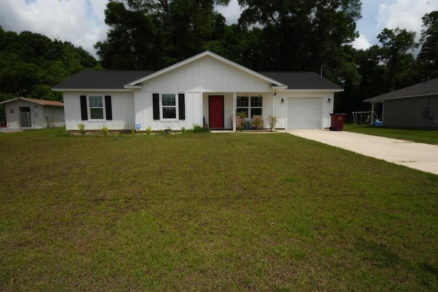 5594 Riviera Dr, Milton, FL 32583 - ranch-style home featuring an attached garage, board and batten siding, a front yard, and concrete driveway