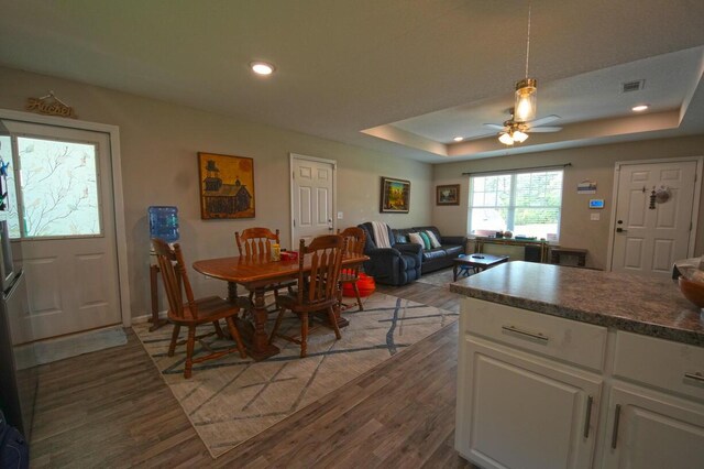5594 Riviera Dr, Milton, FL 32583 - dining room featuring a ceiling fan, visible vents, light wood-type flooring, a tray ceiling, and recessed lighting