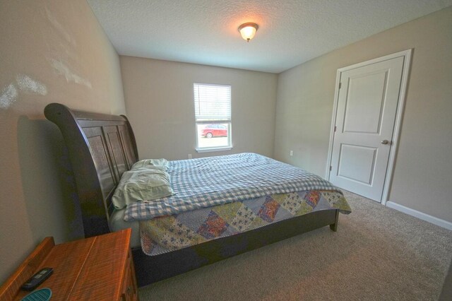 5594 Riviera Dr, Milton, FL 32583 - bedroom featuring a textured ceiling, baseboards, and carpet